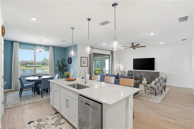 a large kitchen with a table and chairs