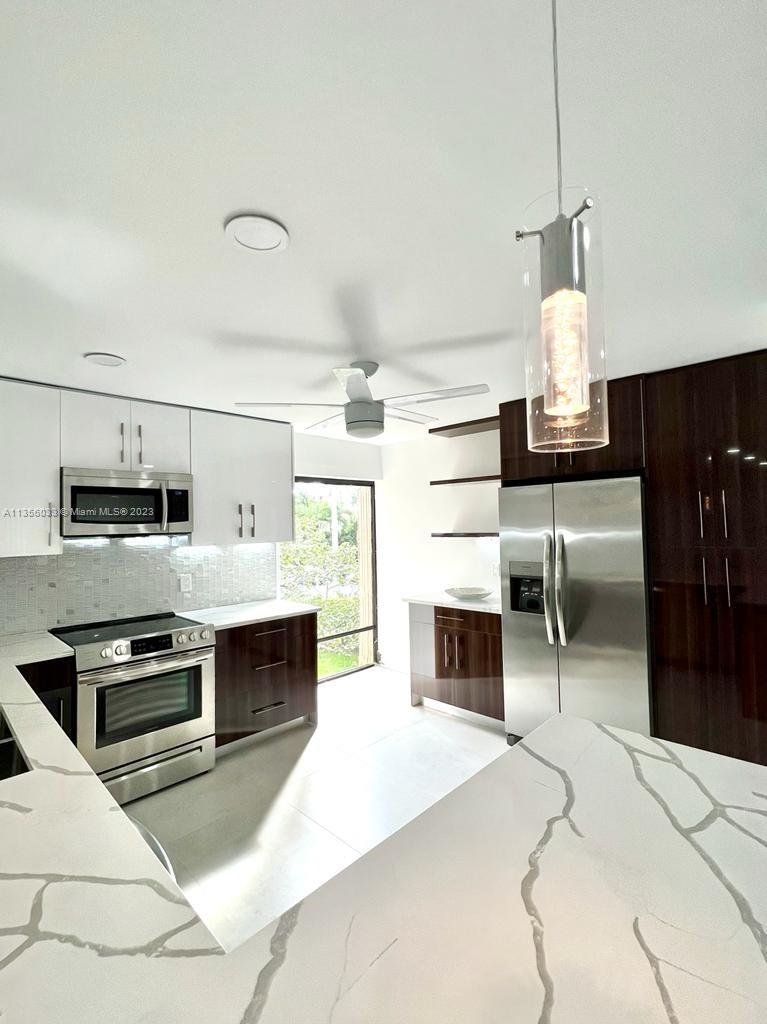 a kitchen with stainless steel appliances a stove and cabinets