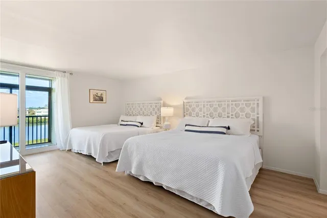 a bedroom with two beds and a dresser