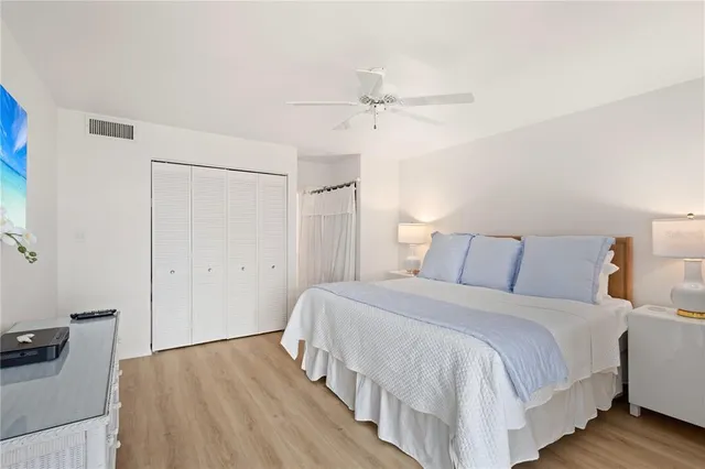 a bedroom with a bed and a ceiling fan