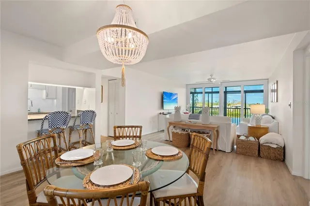 a view of a dining room with furniture wooden floor and chandelier