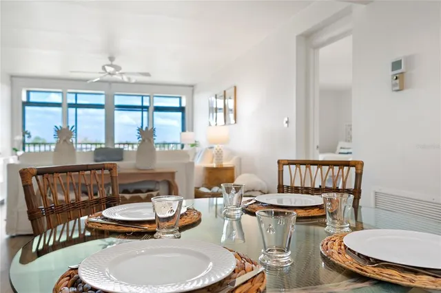 a dining room with furniture a rug and a chandelier