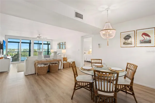 a view of a dining room with furniture wooden floor and chandelier