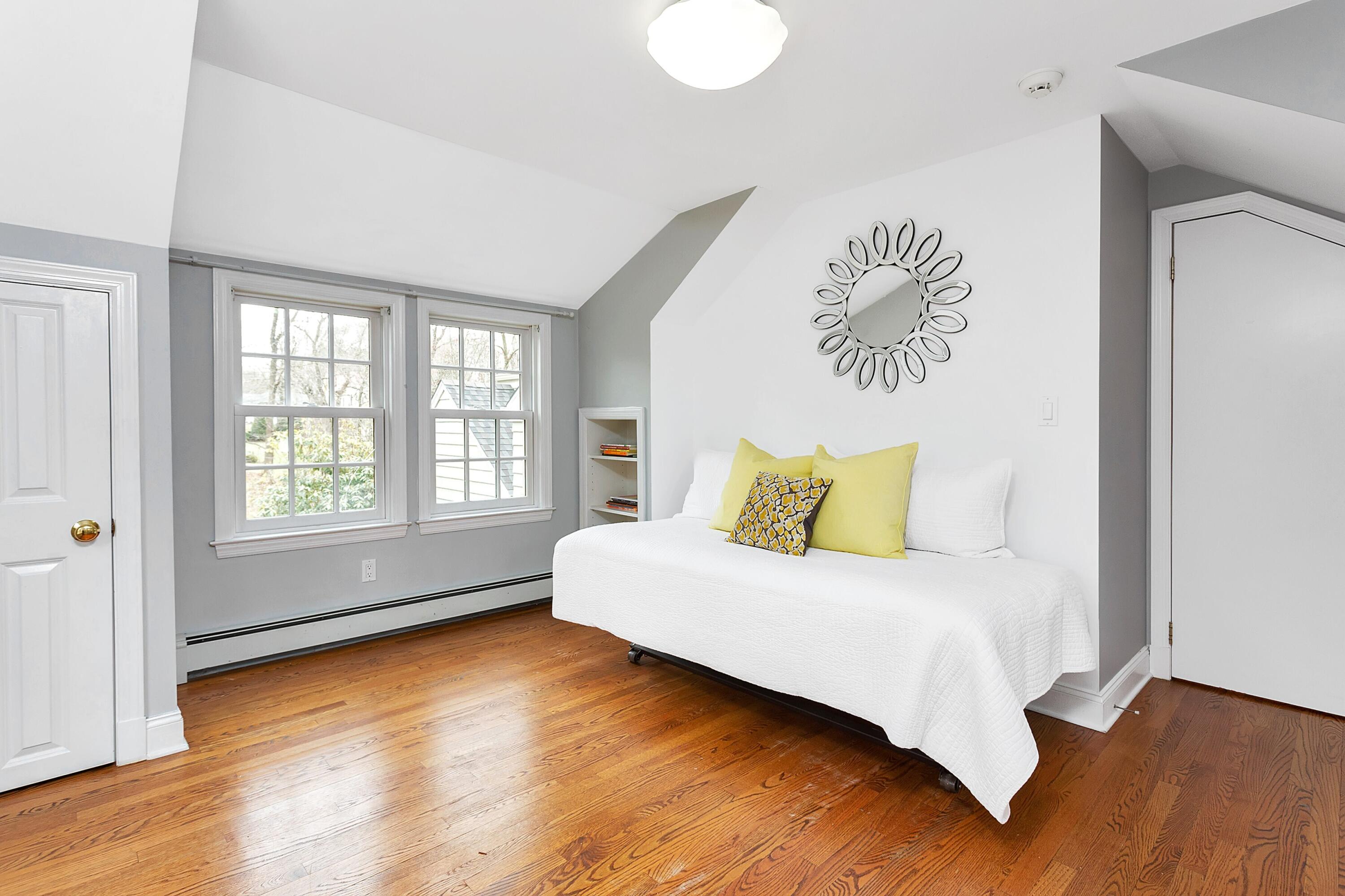 36 Sunset Road Darien, CT 06820 - Photo 22 of 38 a large bedroom with a bed and wooden floor