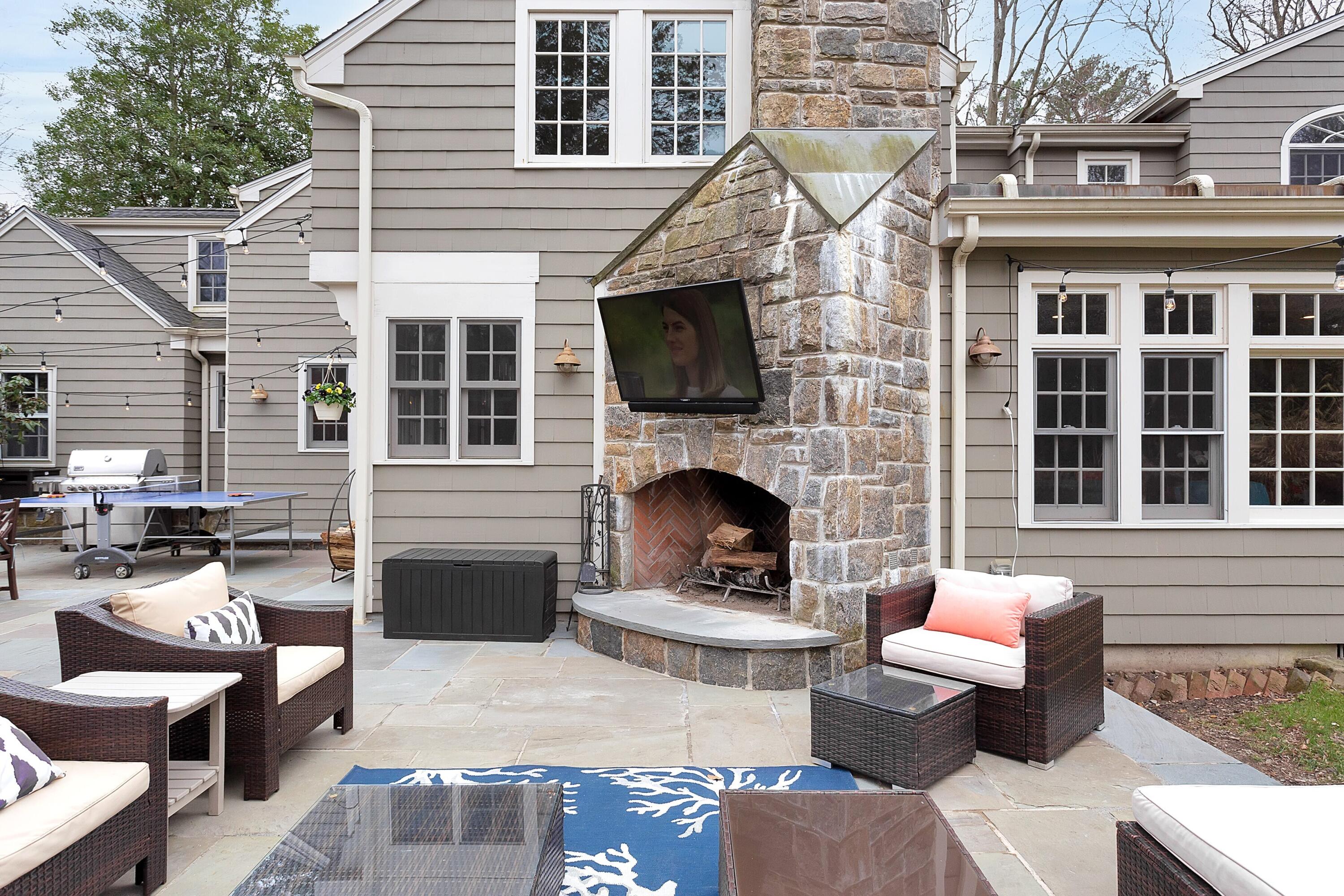36 Sunset Road Darien, CT 06820 - Photo 33 of 38 a view of a patio with couches chairs and a fire pit