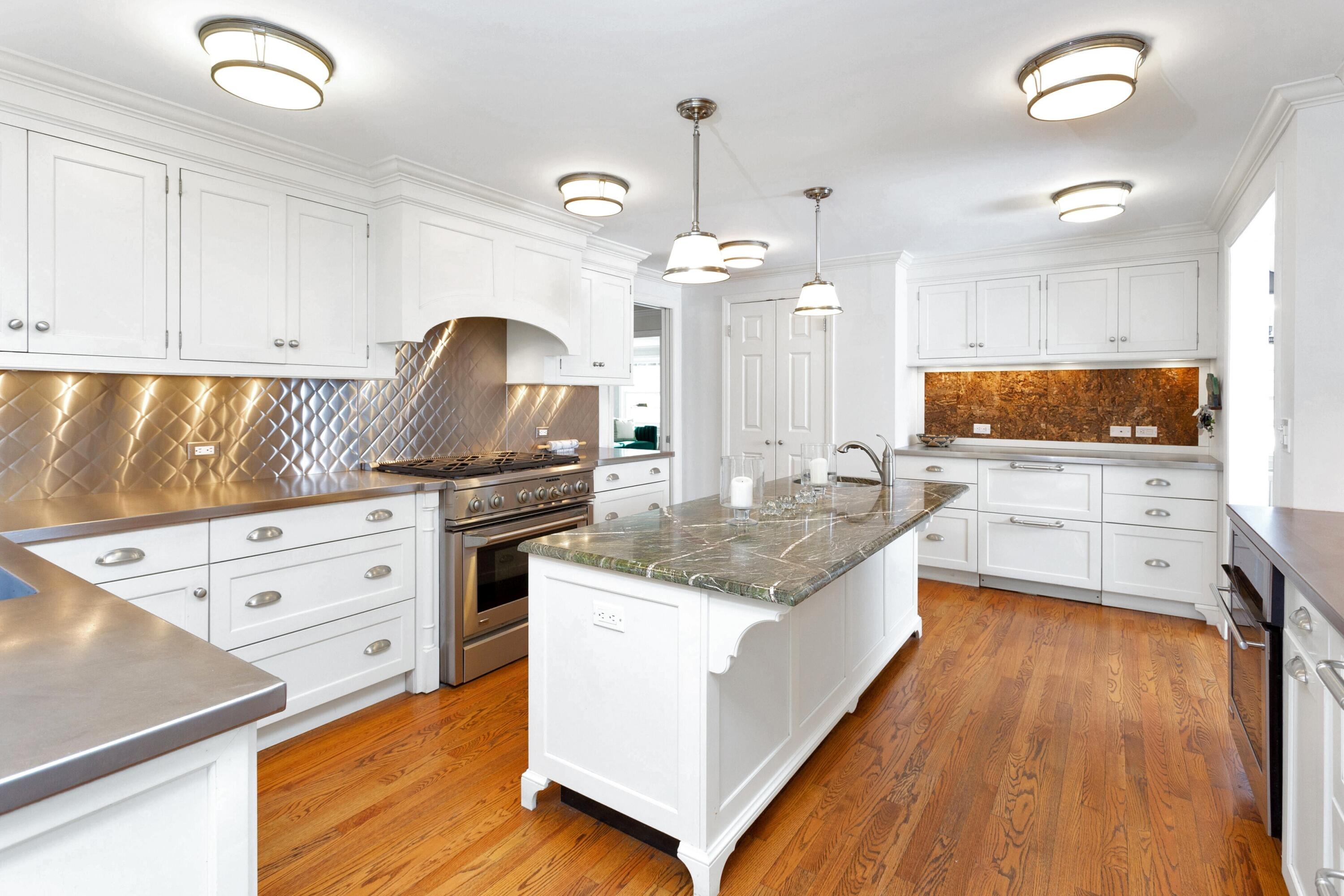 36 Sunset Road Darien, CT 06820 - Photo 8 of 38 a large kitchen with granite countertop a large counter top space a sink stainless steel appliances and cabinets