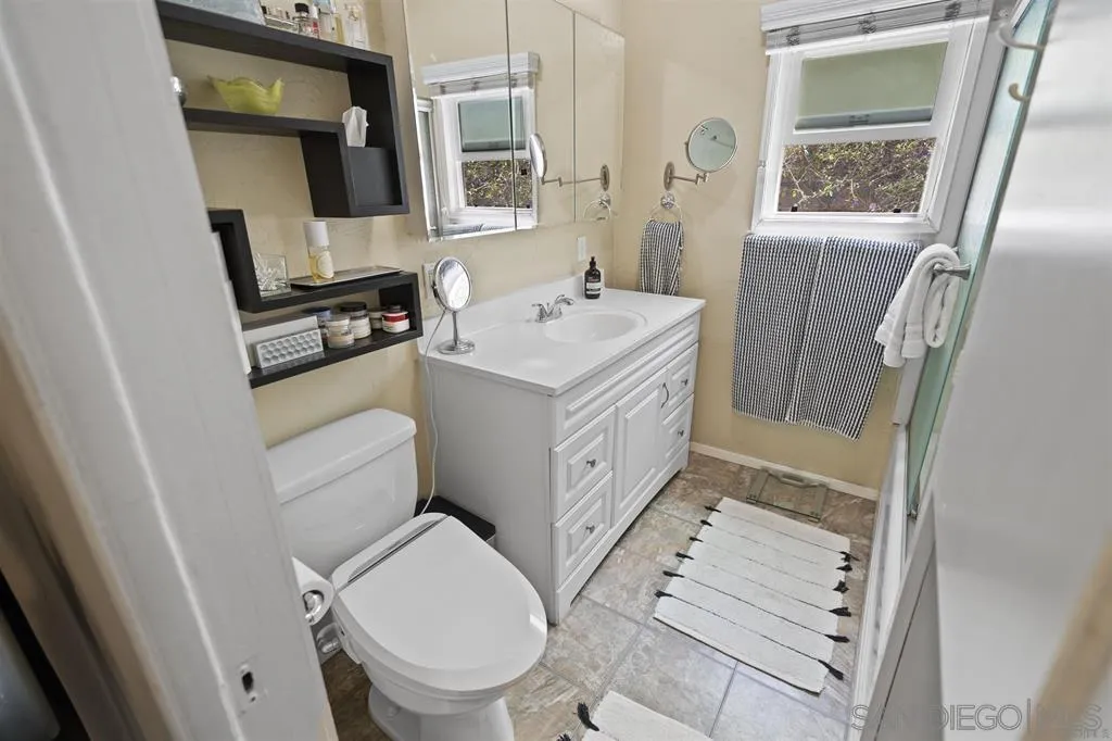 353 3rd Street Encinitas, CA 92024 - Photo 14 of 33 a bathroom with a sink toilet and mirror