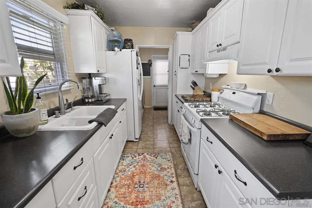 353 3rd Street Encinitas, CA 92024 - Photo 20 of 33 a kitchen with a sink stove and refrigerator