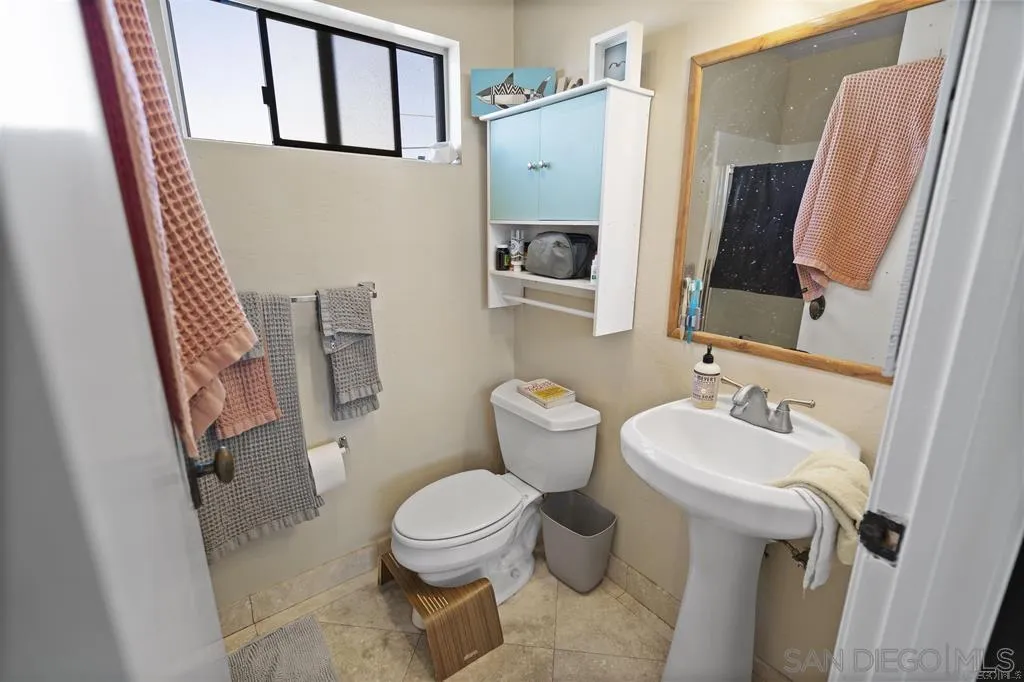 353 3rd Street Encinitas, CA 92024 - Photo 25 of 33 a bathroom with a toilet sink and mirror