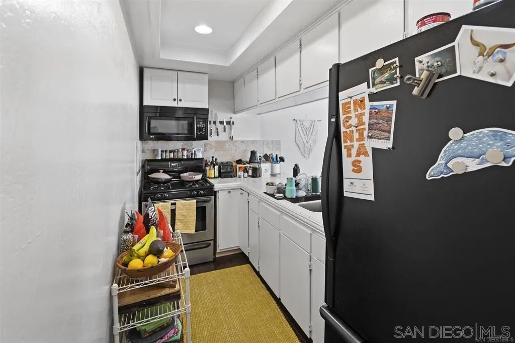 353 3rd Street Encinitas, CA 92024 - Photo 27 of 33 a kitchen with stainless steel appliances a refrigerator and a stove top oven