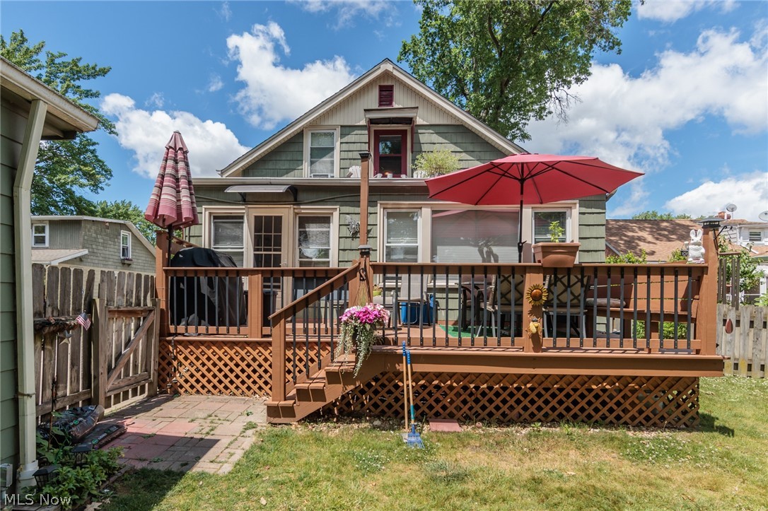 5364 Summit Road Lyndhurst, OH 44124 - Photo 42 of 42 Rear exterior featuring a spacious wood deck with lattice skirting, direct yard access, and a ground-level brick patio