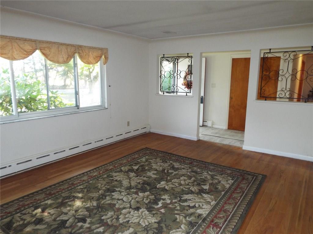 125 North Eberhart Road Butler, PA 16001 - Photo 6 of 19 Living Room has large window for natural light and intricate wrought iron decorations.