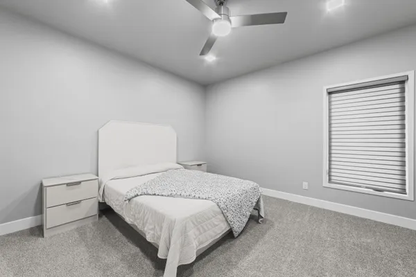 a bedroom with a bed and a large window