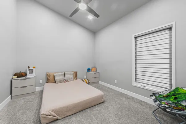 a bedroom with a bed and a potted plant