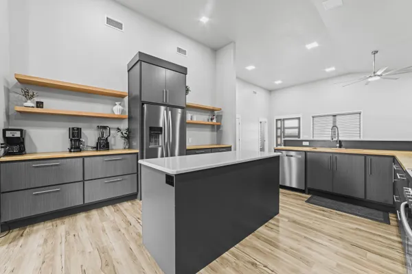 a kitchen with stainless steel appliances granite countertop a sink and cabinets