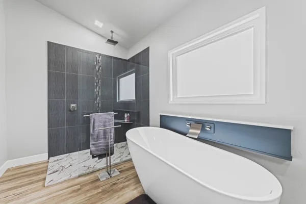 a bathroom with a bathtub and a sink