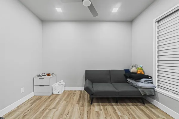 a living room with furniture and a wooden floor