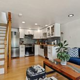 a kitchen with a refrigerator and a couch