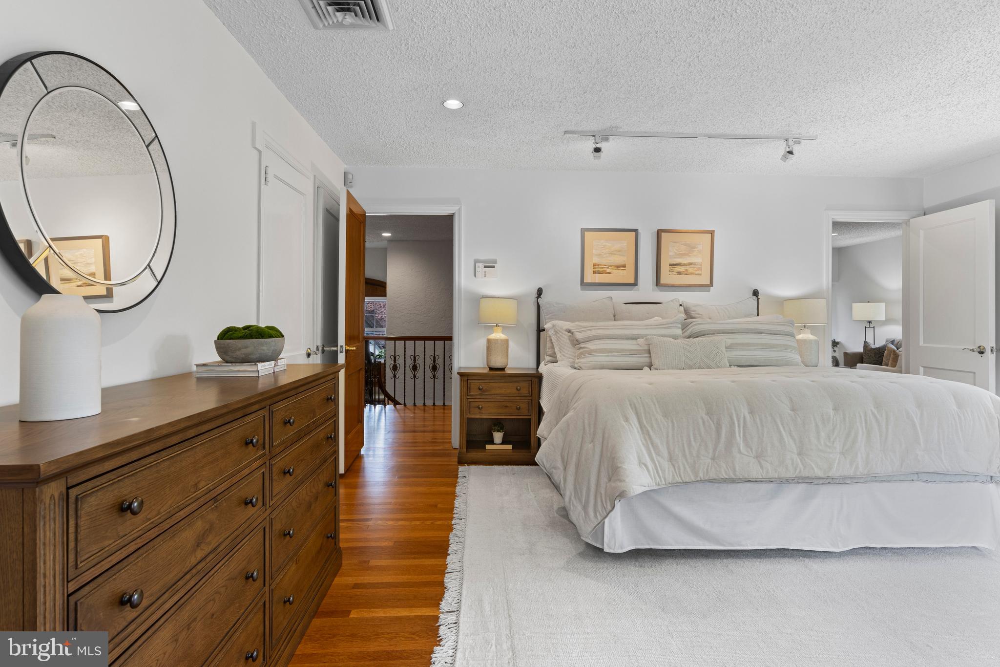 857 Meetinghouse Road Rydal, PA 19046 - Photo 34 of 93 a spacious bedroom with a large bed and a mirror