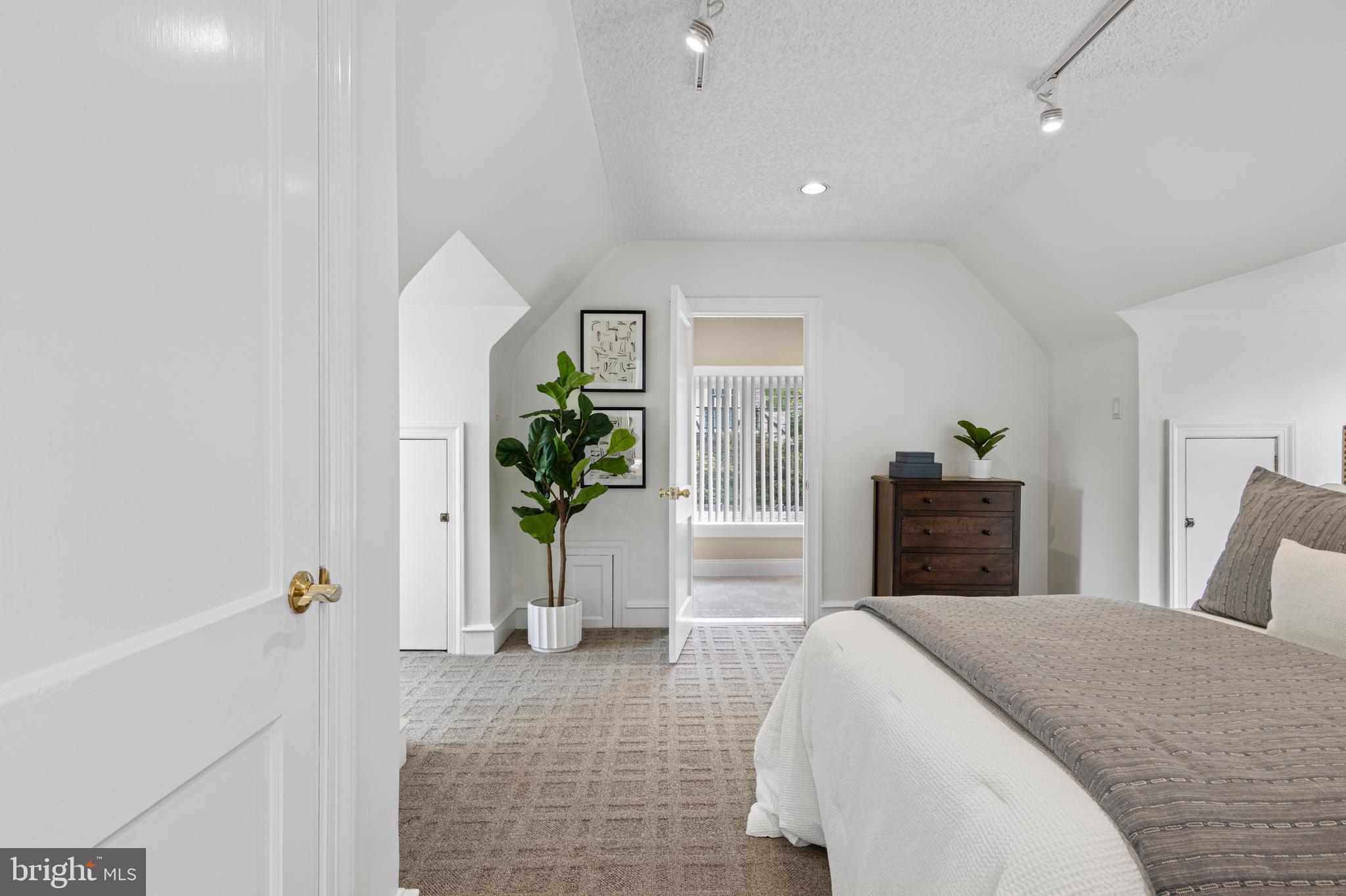 857 Meetinghouse Road Rydal, PA 19046 - Photo 49 of 93 a spacious bedroom with a bed and a potted plant