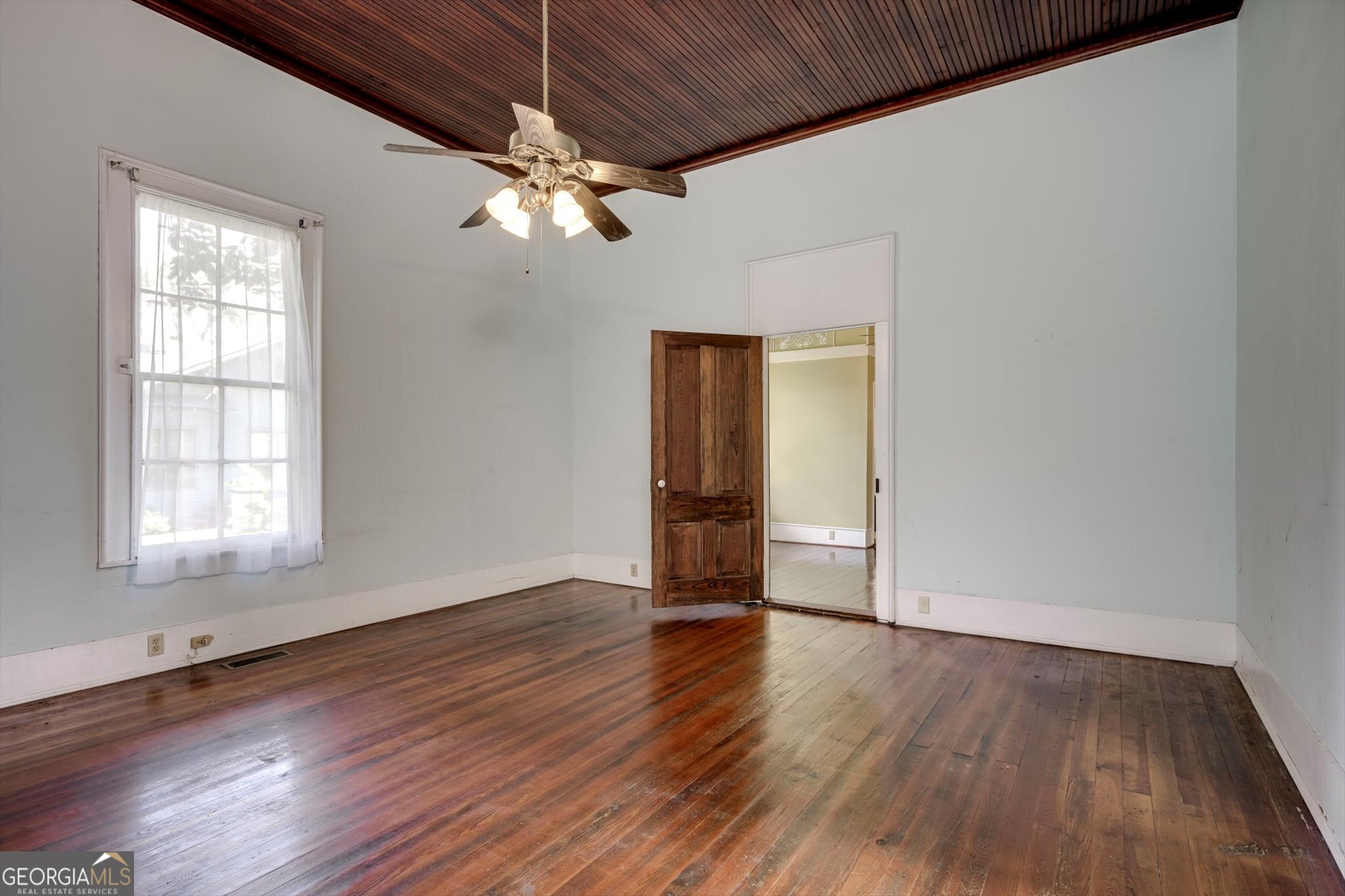 314 White Oak Street Thomson, GA 30824 - Photo 11 of 14 a view of an empty room with wooden floor and a window