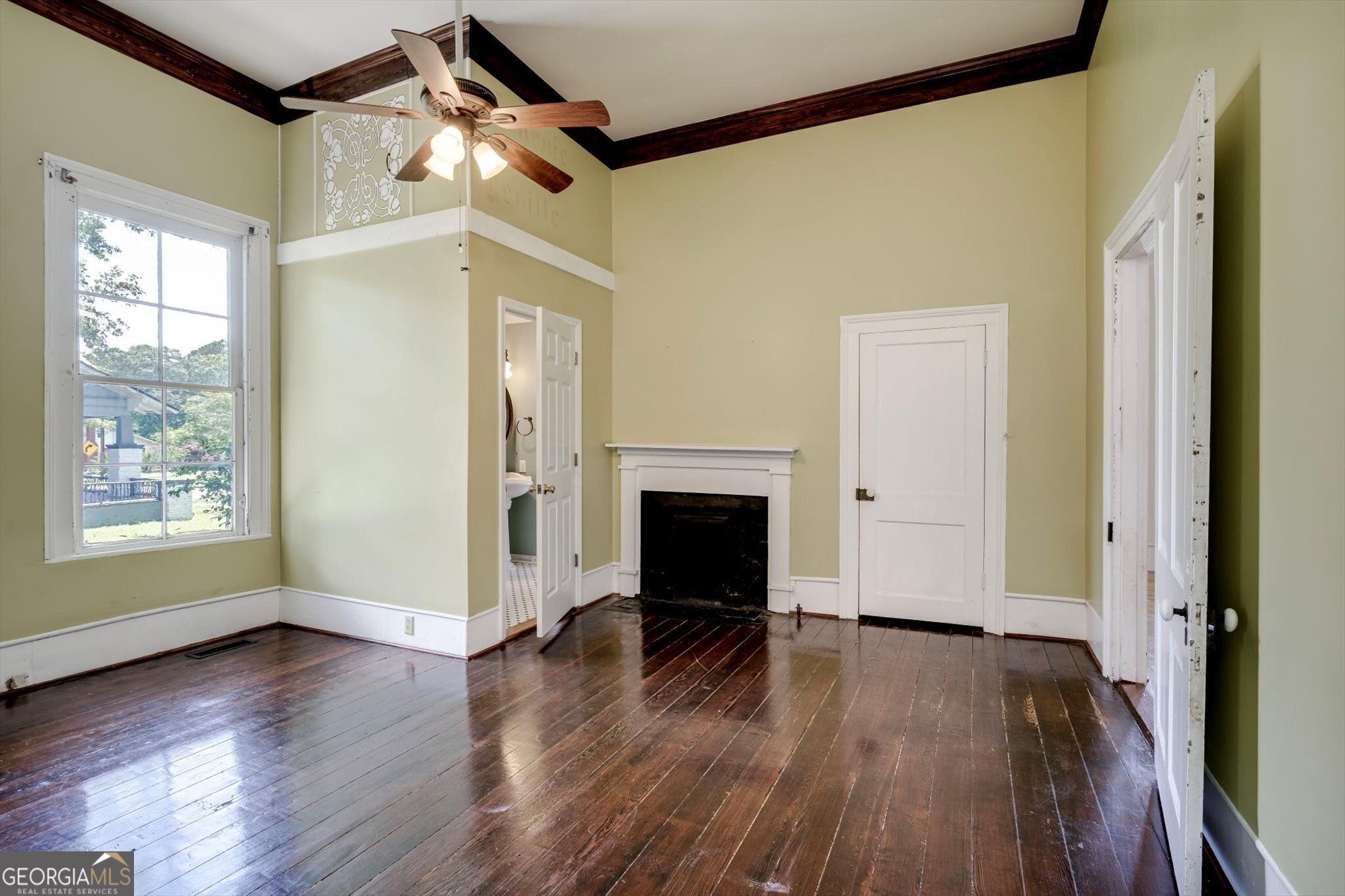314 White Oak Street Thomson, GA 30824 - Photo 12 of 14 a view of a livingroom with wooden floor a fireplace and window