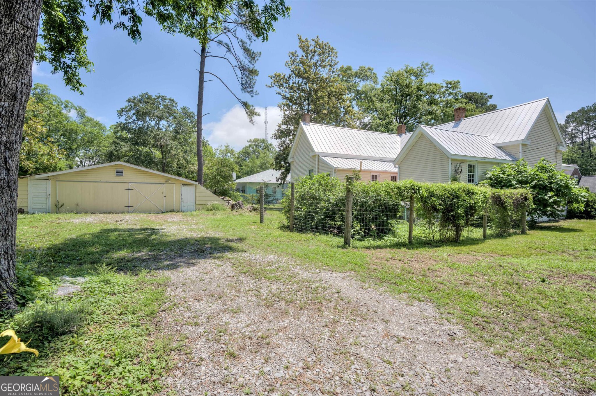 314 White Oak Street Thomson, GA 30824 - Photo 14 of 14 a view of a backyard with potted plants and a large tree
