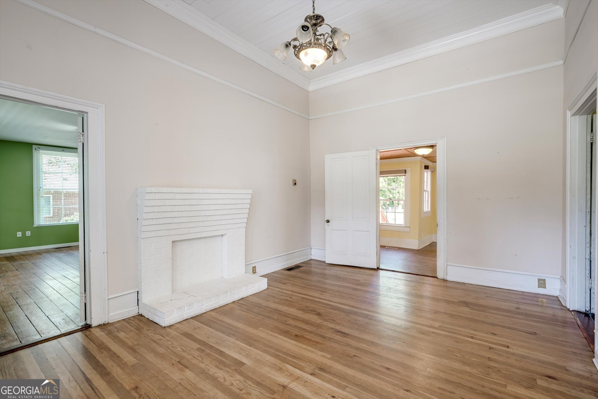 314 White Oak Street Thomson, GA 30824 - Photo 3 of 14 wooden floor in an empty room with a window