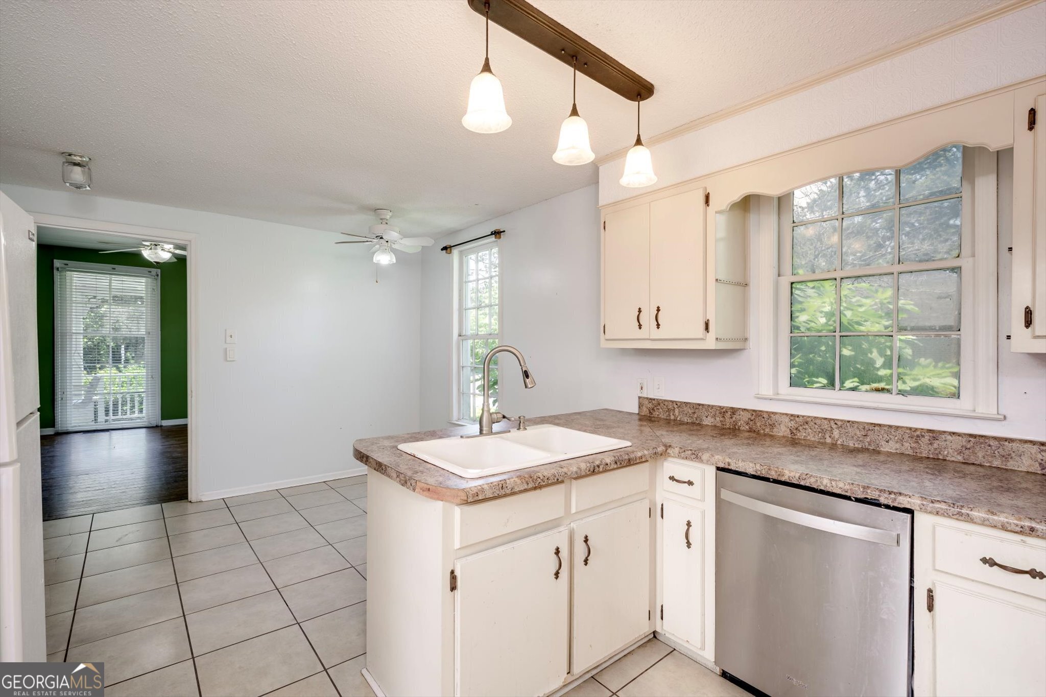 314 White Oak Street Thomson, GA 30824 - Photo 7 of 14 a kitchen with a sink a counter top space and stainless steel appliances