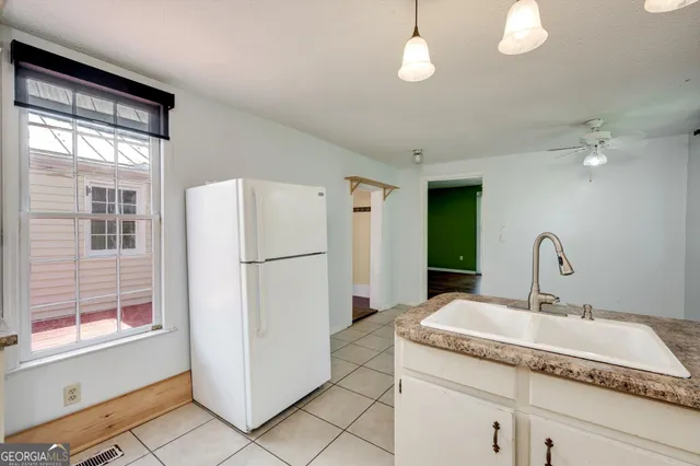 a kitchen with a refrigerator and a sink