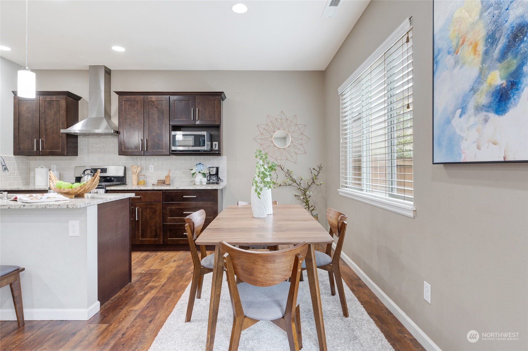 3026 183rd Street Southeast Bothell, WA 98012 - Photo 12 of 39 a kitchen with stainless steel appliances a dining table chairs and a refrigerator