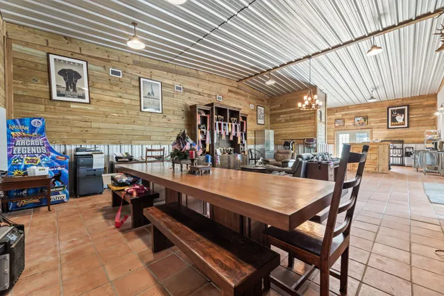a view of a patio with dining table and chairs with wooden floor