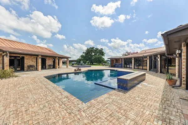 a view of a house with backyard and sitting area