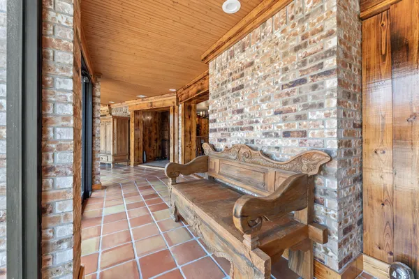 a view of a balcony with chairs and door