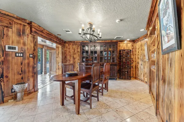 a view of a dining room with furniture and chandelier