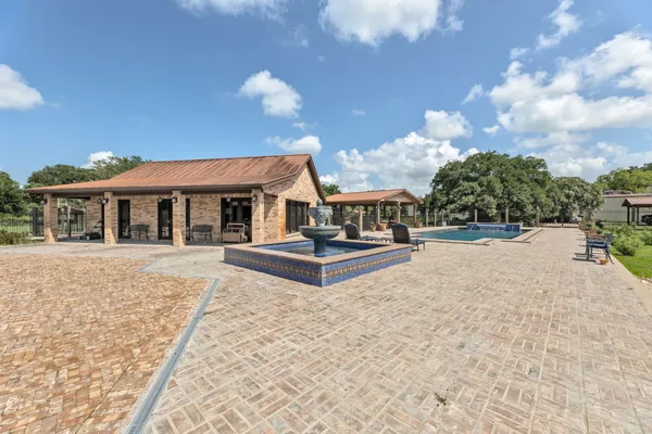 a view of a house with backyard porch and sitting area