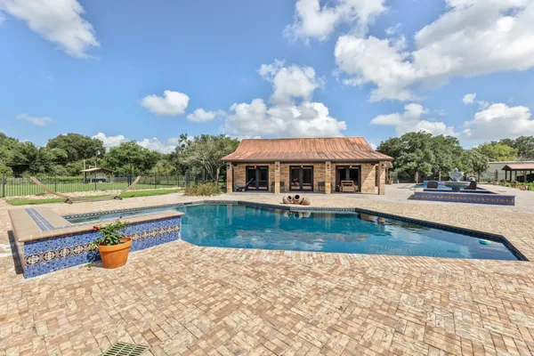 swimming pool view with a garden space