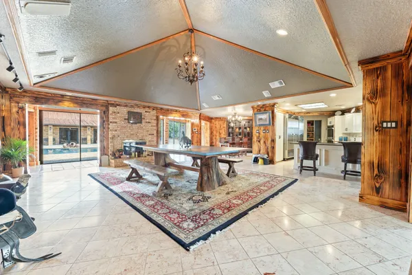 a living room with fireplace furniture and a large window