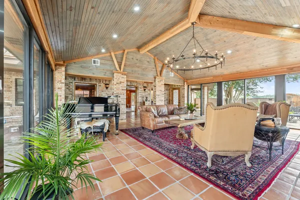 a living room with patio furniture and a floor to ceiling window