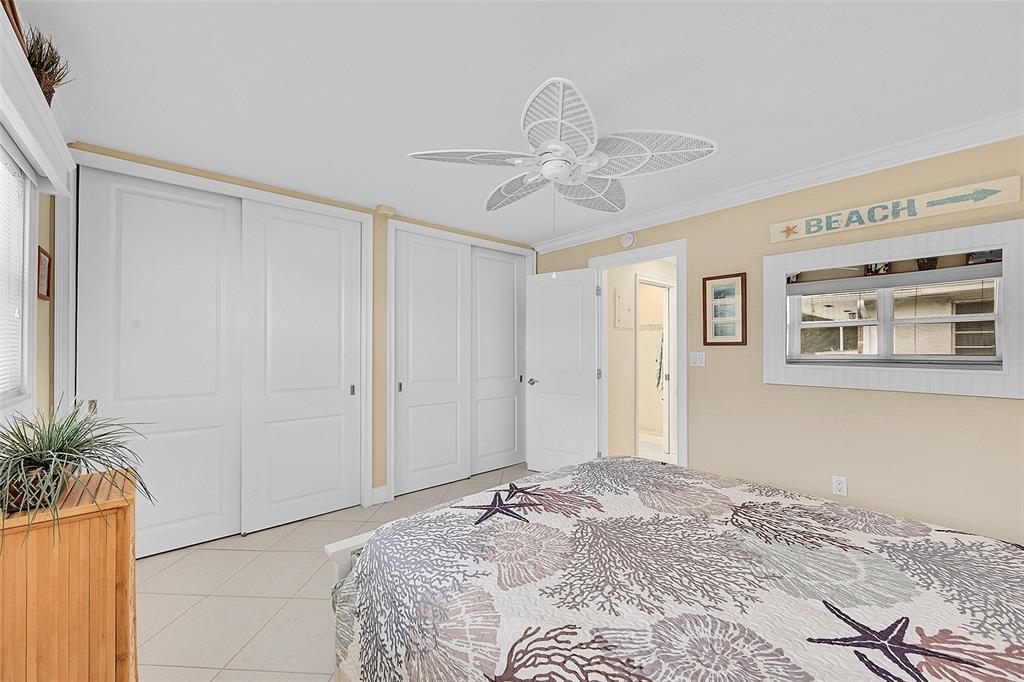 1110 North Riverside Drive, Unit 24 Pompano Beach, FL 33062 - Photo 30 of 43 Lots of closet space, CROWN MOLDING THROUGHOUT ENTIRE CONDO and the same ceramic tile floors throughout your condo. Your Large Primary Bedroom has IMPACT WINDOWS, WOOD & BLACK-OUT BLINDS & BEING SOLD FURNISHED (some exclusions).