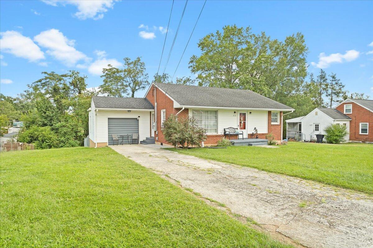 218 Post Road Roanoke, VA 24019 - Photo 2 of 24 a front view of a house with a garden and trees