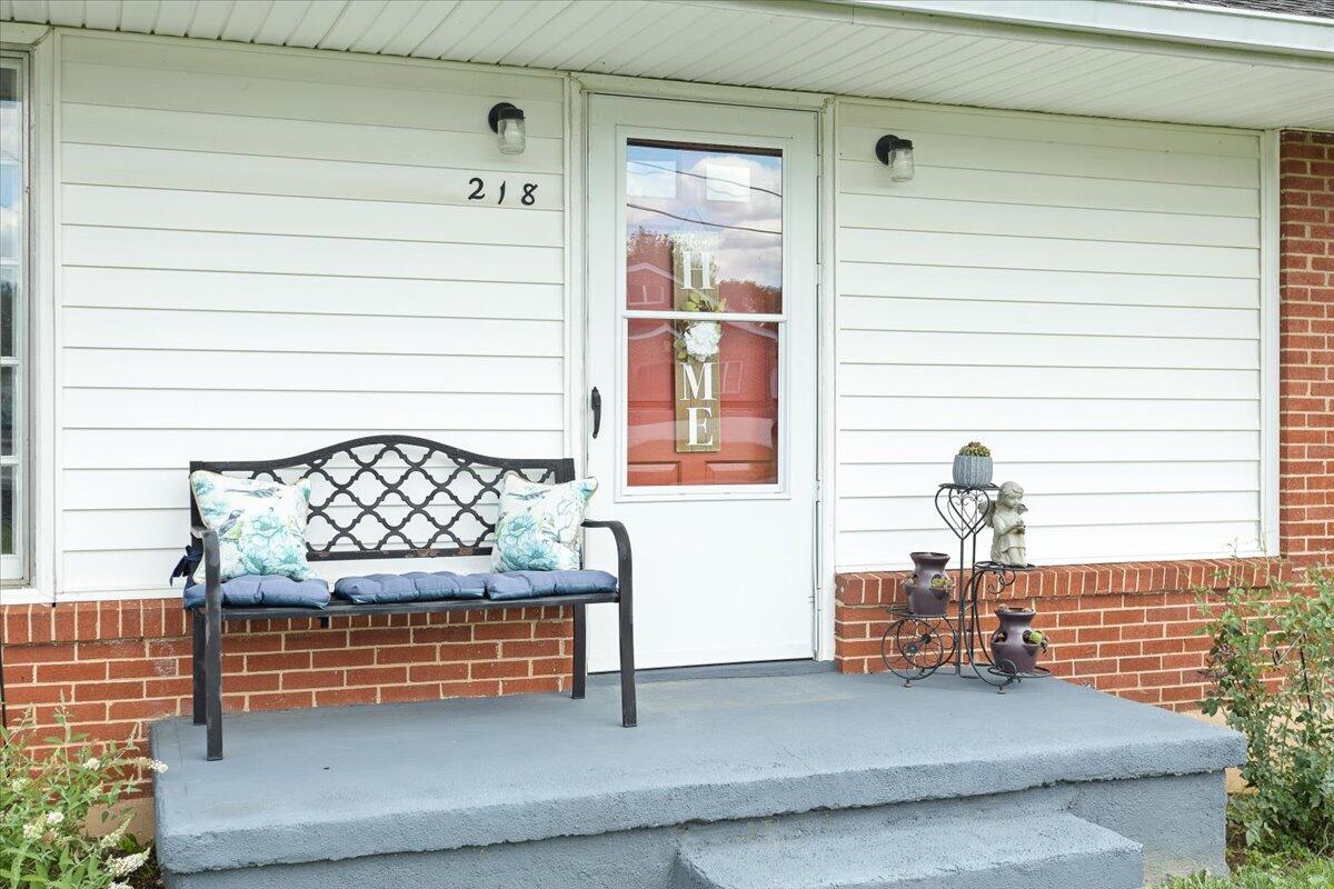 218 Post Road Roanoke, VA 24019 - Photo 4 of 24 a glass door and bench sitting in front of a door