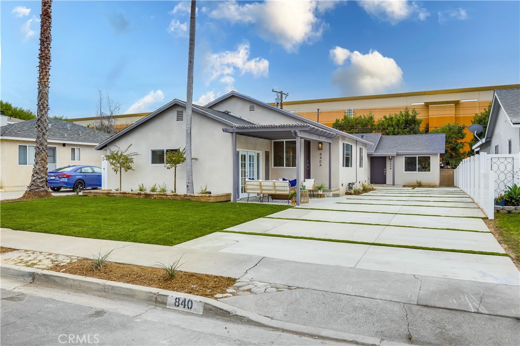 a front view of house with yard and green space