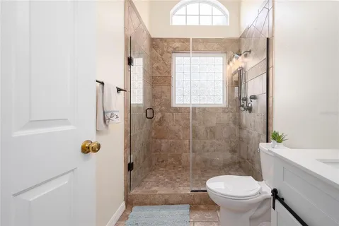 a bathroom with a shower a toilet and a sink