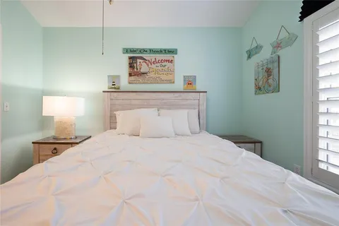 a bedroom with a bed and a night stand