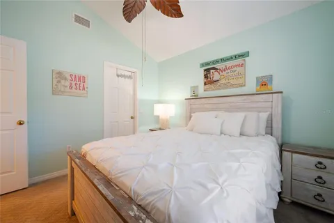 a bedroom with a bed and a painting on the wall