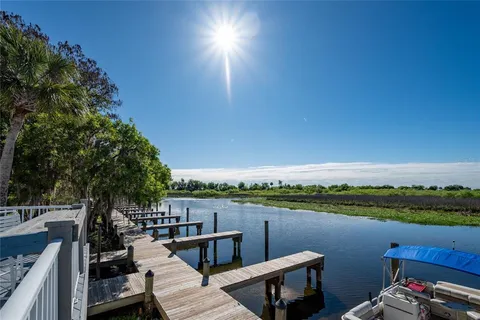 a view of a lake with couches chairs