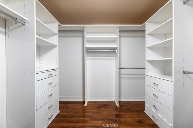 a view of walk in closet with empty racks