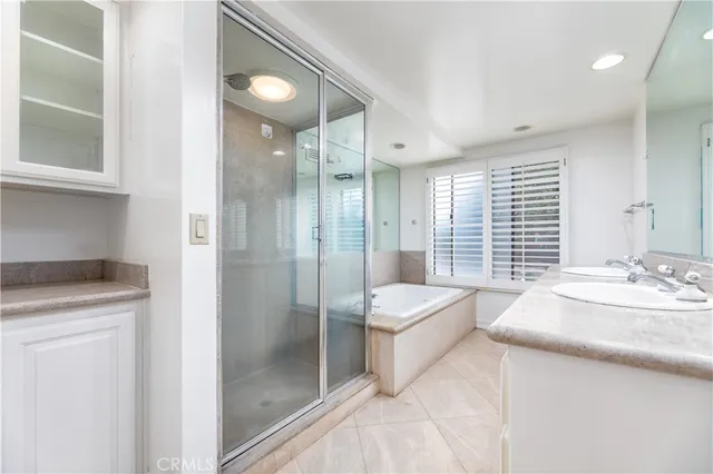 a spacious bathroom with a sink a toilet and shower