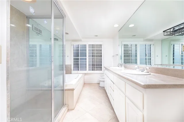 a spacious bathroom with a granite countertop tub sink and shower